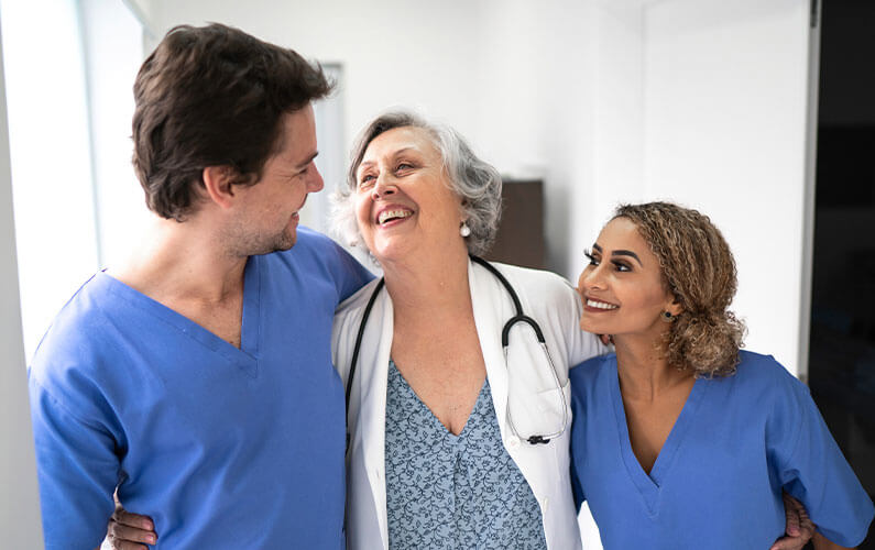 group of family doctors smiling at each other