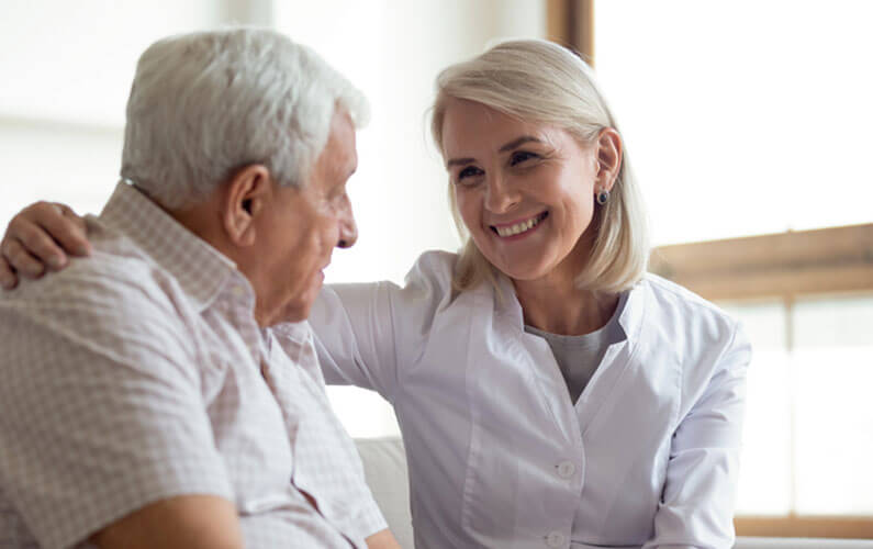 Older woman putting her arm around her husband