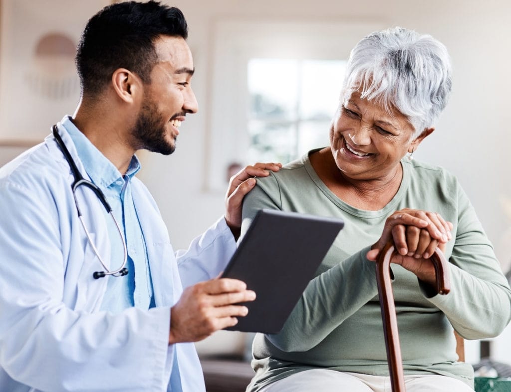young doctor sharing information from his digital tablet with an Senior patient