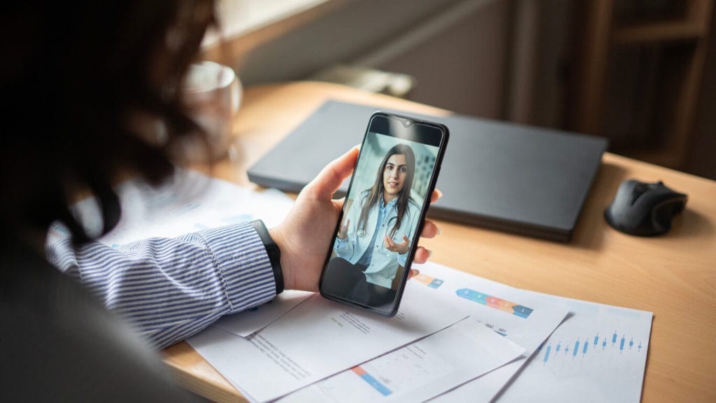 Businesswoman making video call with doctor