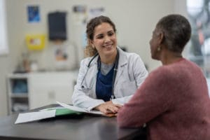 A senior patient talking to her doctor at a Primary Care Walk-In Clinic