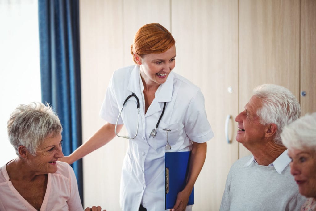 Image of a happy female doctor specializing in elderly care with her senior patient.