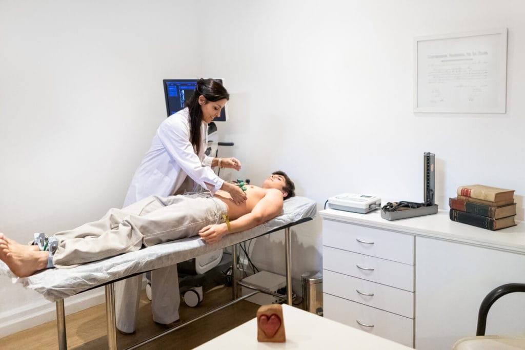 Cardiologist performing an echocardiogram on a teenage patient