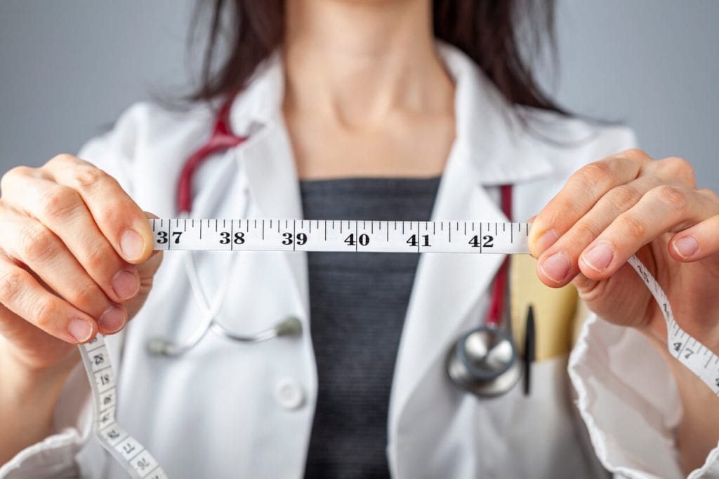 Medical Weight Loss Doctor with tape measure