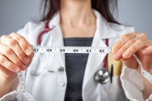 Medical Weight Loss Doctor with tape measure