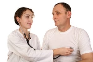 A female doctor is conducting an annual physical check-up for her senior male patient.