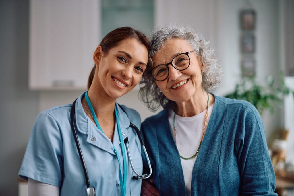 A happy senior woman and a female primary care physician at a family medical clinic.